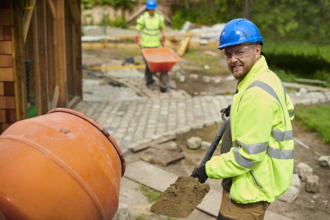 landscape contractor loading the cement mixer